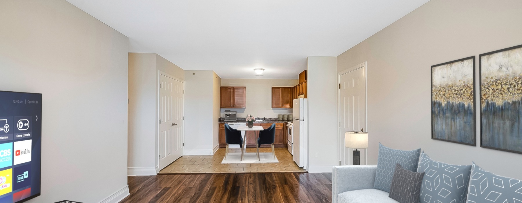 Livingroom with couch and TV, straight ahead is the eat in kitchen